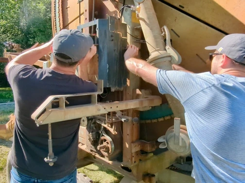 FarmHQ support team works on a hard hose irrigation reel