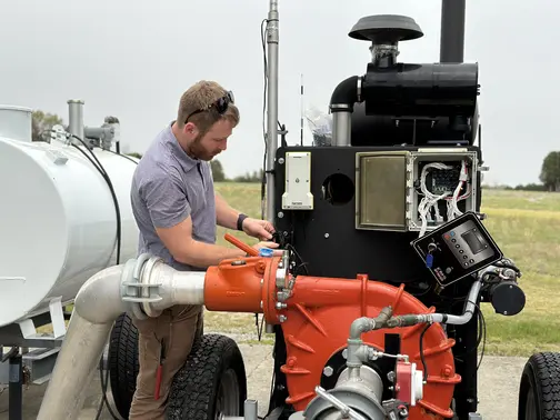 gabe-installing-on-orange-pump-side-profile FarmHQ integrates with your pump for irrigation timers!